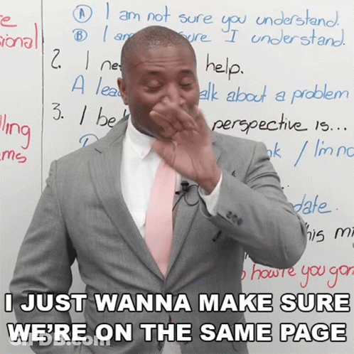 A Man In A Suit And Pink Tie Is Covering His Nose In Front Of A Whiteboard That Says I Just Wanna GIF