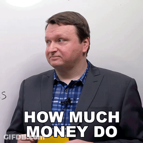 A Man In A Suit And Plaid Shirt Is Holding A Yellow Sticky Note That Says How Much Money Do GIF