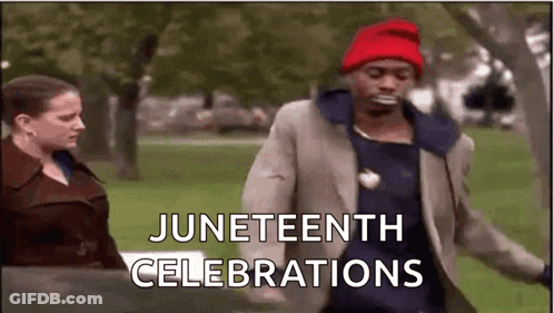 A Man In A Suit And Red Hat Is Dancing In A Park . GIF