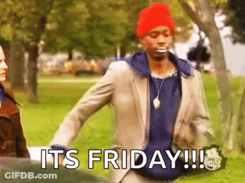 A Man In A Suit And Red Hat Is Walking In A Park With The Words `` It 'S Friday '' Written On His Face . GIF