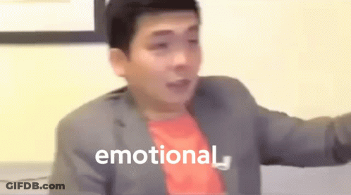 A Man In A Suit And Red Shirt Is Making A Funny Face And The Word Emotional Is Visible In The Background . GIF
