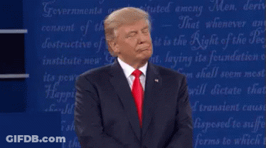 A Man In A Suit And Red Tie Is Standing In Front Of A Blue Board With The Words " Governments " On It GIF