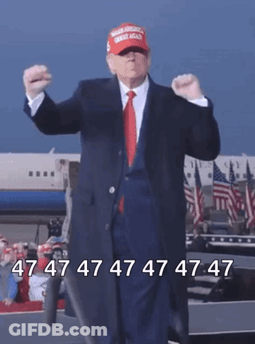 A Man In A Suit And Red Tie Is Wearing A Maga Hat And Dancing GIF