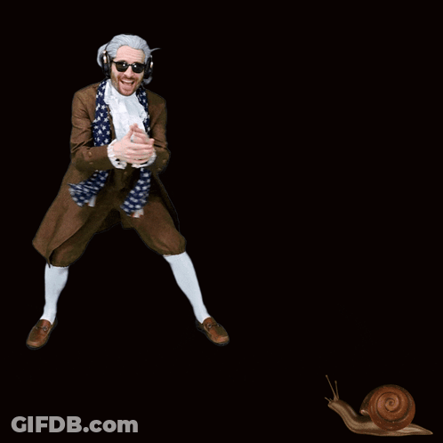A Man In A Suit And Scarf Is Dancing With A Snail Behind Him GIF