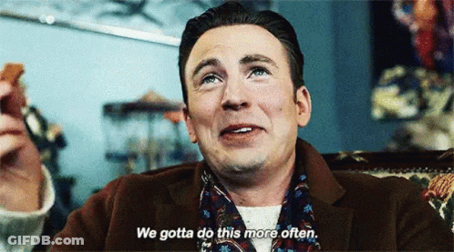 A Man In A Suit And Scarf Is Sitting In A Chair And Saying `` We Gotta Do This More Often '' GIF