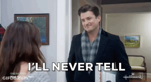 A Man In A Suit And Scarf Is Talking To A Woman In A Hallway . GIF