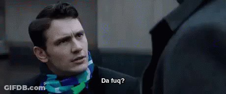 A Man In A Suit And Scarf Is Talking To Another Man In A Suit And Scarf . GIF