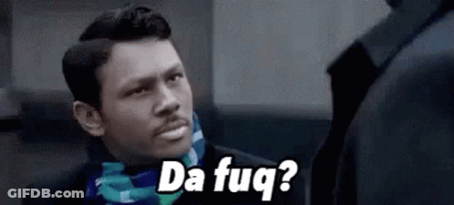 A Man In A Suit And Scarf Is Talking To Another Man While Wearing A Scarf . GIF