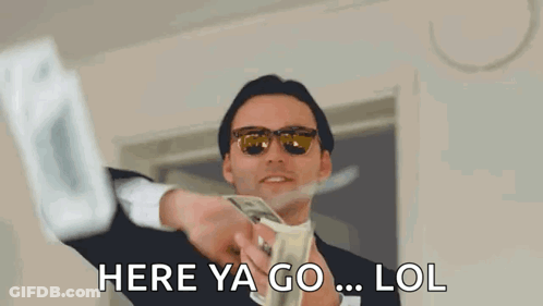 A Man In A Suit And Sunglasses Is Holding A Bunch Of Money In His Hand . GIF