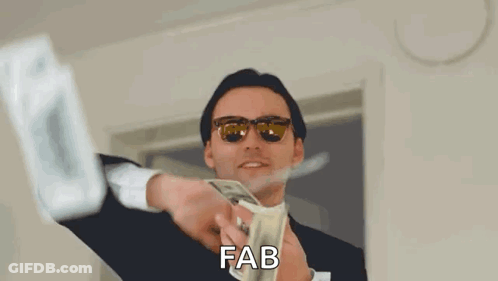 A Man In A Suit And Sunglasses Is Holding A Bunch Of Money In His Hands . GIF