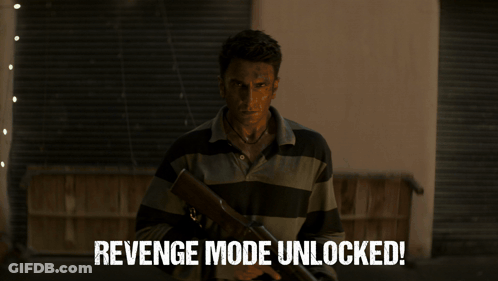 A Man In A Suit And Sunglasses Is Standing In A Hallway With The Words Revenge Mode Unlocked Written Below Him GIF