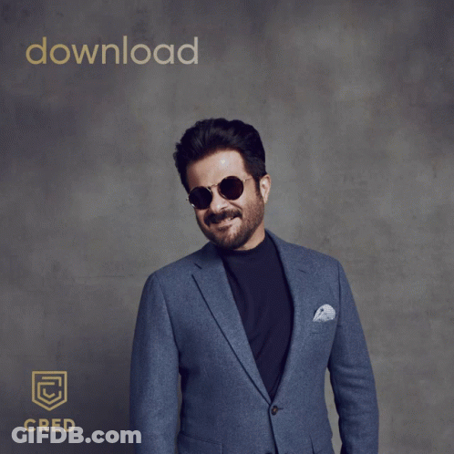 A Man In A Suit And Sunglasses Pointing At The Camera With The Words Download Cred Behind Him GIF