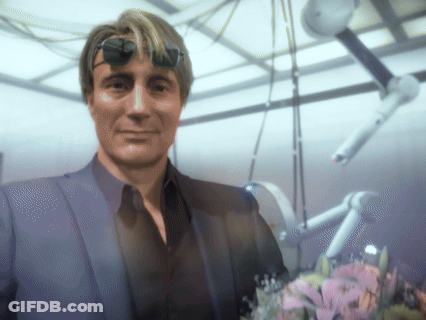 A Man In A Suit And Sunglasses Stands In A Room GIF
