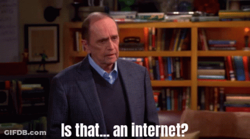 A Man In A Suit And Sweater Is Asking Is That An Internet GIF