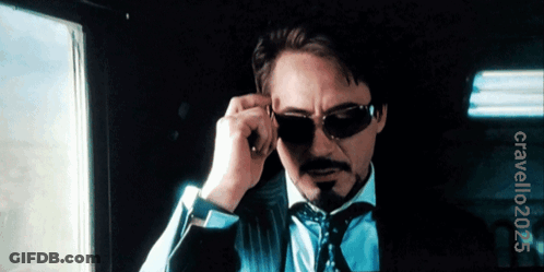 A Man In A Suit And Tie Adjusts His Sunglasses With A Watermark That Says Clavellooz3 On The Bottom GIF