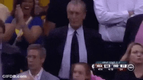 A Man In A Suit And Tie Applauds During A Basketball Game Between Miami And Indiana GIF