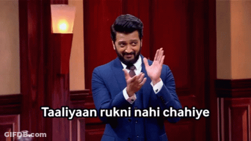 A Man In A Suit And Tie Applauds With The Words Taaliyaan Rukni Nahi Chahiye Above Him GIF