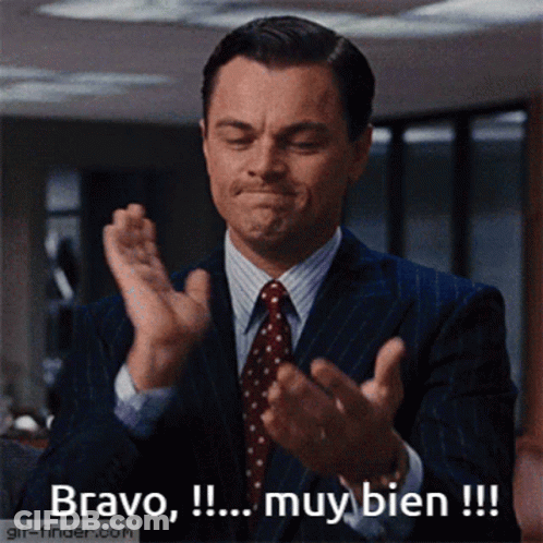 A Man In A Suit And Tie Clapping With The Words Bravo Muy Bien GIF