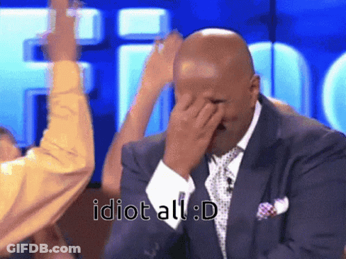 A Man In A Suit And Tie Covering His Face With His Hand With The Words Idiot All : D Written Below Him GIF