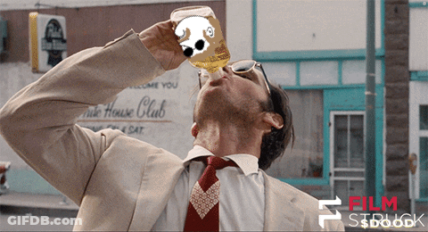 A Man In A Suit And Tie Drinks From A Bottle With A Dog On It GIF