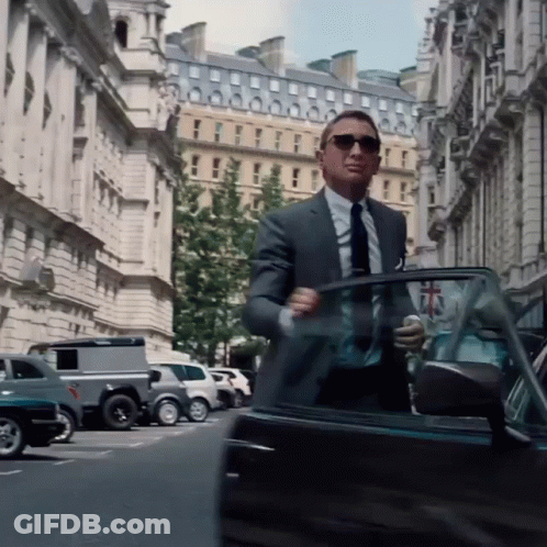 A Man In A Suit And Tie Gets Out Of A Car GIF