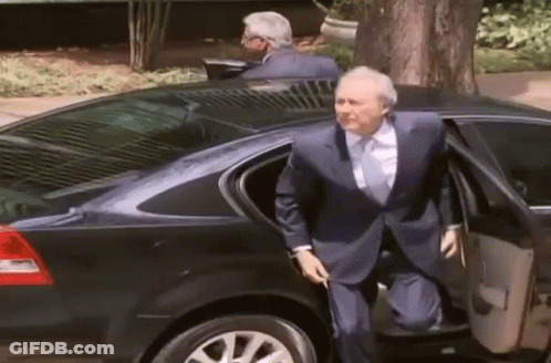 A Man In A Suit And Tie Gets Out Of A Car GIF