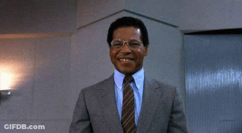 A Man In A Suit And Tie Giving A Thumbs Up GIF