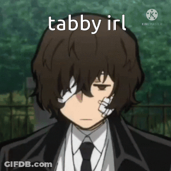 A Man In A Suit And Tie Has A Bandage On His Eye And The Words Tabby Irl Above Him . GIF