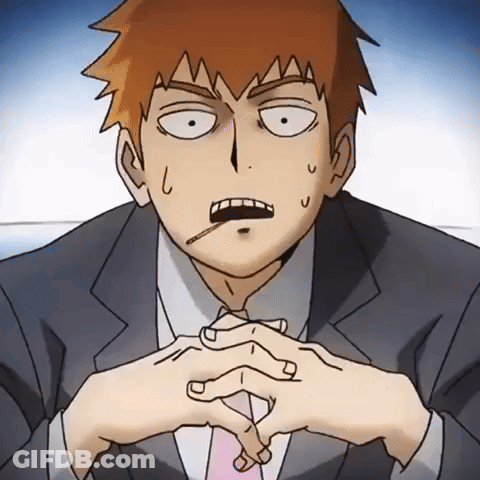 A Man In A Suit And Tie Has A Cigarette In His Mouth GIF