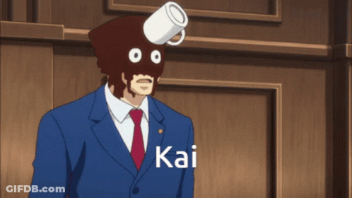 A Man In A Suit And Tie Has A Cup On His Head And The Name Kai Is On The Bottom GIF