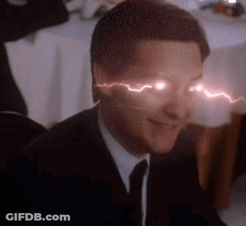 A Man In A Suit And Tie Has A Lightning Bolt Coming Out Of His Eyes GIF