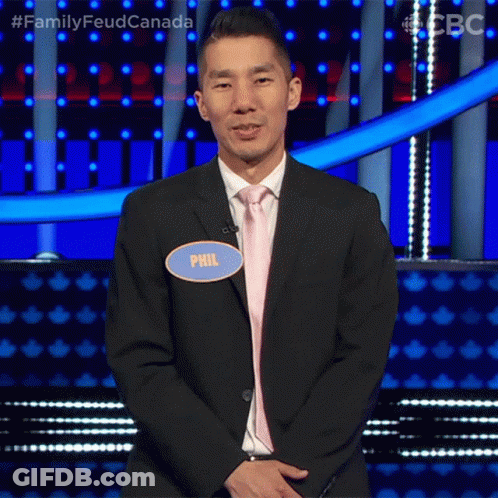 A Man In A Suit And Tie Has A Name Tag That Says Phil On It GIF