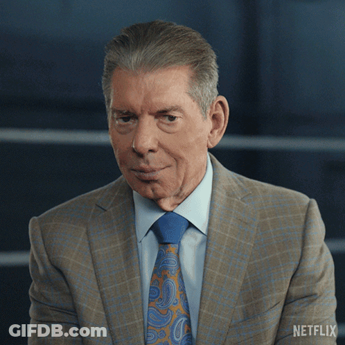 A Man In A Suit And Tie Has A Netflix Logo On His Shoulder GIF
