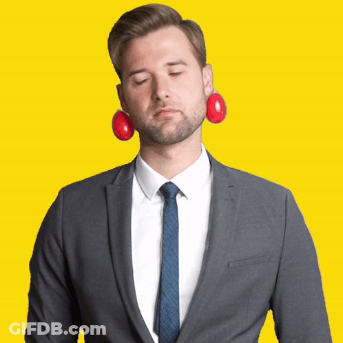 A Man In A Suit And Tie Has A Pair Of Red Eggs In His Ears GIF