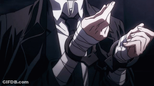 A Man In A Suit And Tie Has His Hands Tied Up With Bandages GIF