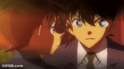 A Man In A Suit And Tie Has The Letter N On His Face GIF