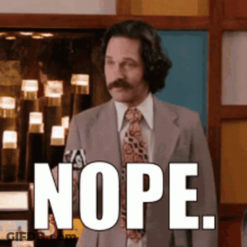 A Man In A Suit And Tie Has The Word Nope On His Face GIF