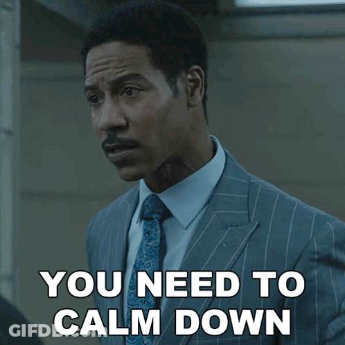 A Man In A Suit And Tie Has The Words You Need To Calm Down Below Him GIF