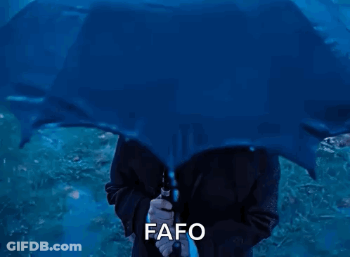 A Man In A Suit And Tie Holding A Blue Umbrella With The Word Fafo Written Below Him GIF