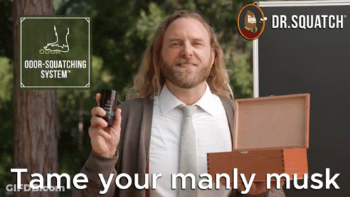 A Man In A Suit And Tie Holding A Bottle Of Odor Squatting System GIF