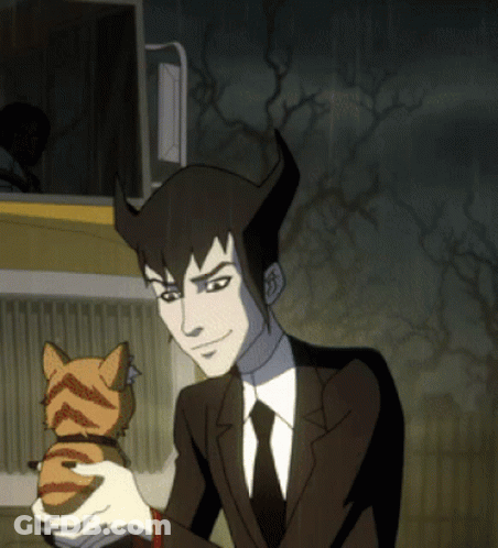 A Man In A Suit And Tie Holding A Cat GIF