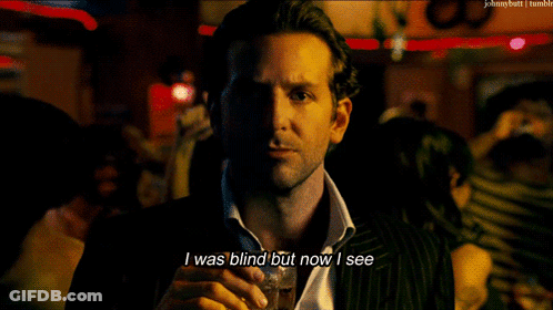 A Man In A Suit And Tie Holds A Glass Of Whiskey And Says I Was Blind But Now I See GIF
