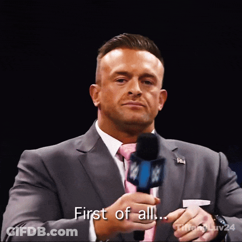 A Man In A Suit And Tie Holds A Microphone And Says " First Of All ... " GIF