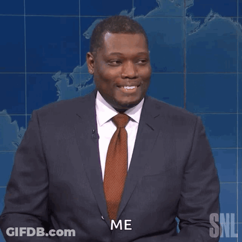 A Man In A Suit And Tie Holds A Pencil And Says Me GIF