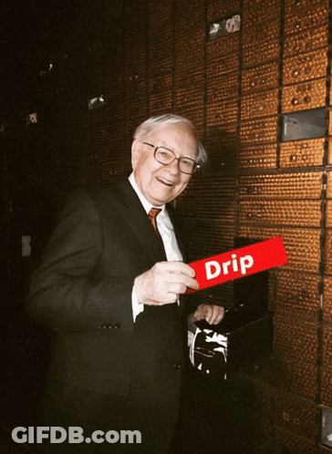 A Man In A Suit And Tie Holds A Red Sign That Says Drip GIF