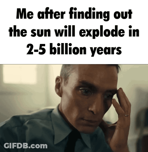 A Man In A Suit And Tie Holds His Hand To His Forehead In Front Of A Sign That Says Me GIF