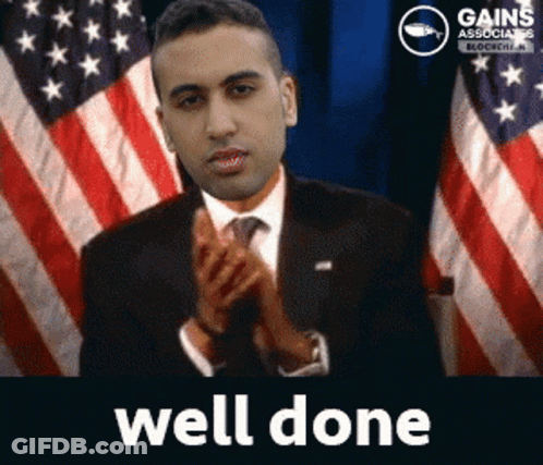 A Man In A Suit And Tie Is Applauding In Front Of An American Flag With The Words Well Done Below Him GIF