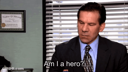 A Man In A Suit And Tie Is Asking If He Is A Hero GIF