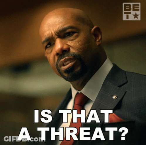 A Man In A Suit And Tie Is Asking If That Is A Threat GIF