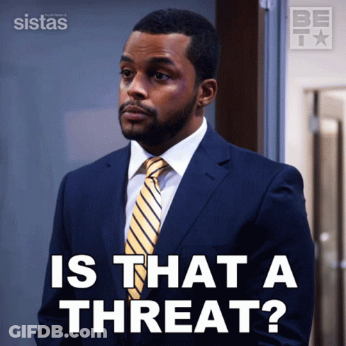 A Man In A Suit And Tie Is Asking If There Is A Threat GIF